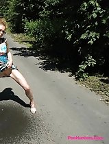 Teeny pissing in the middle of the country road